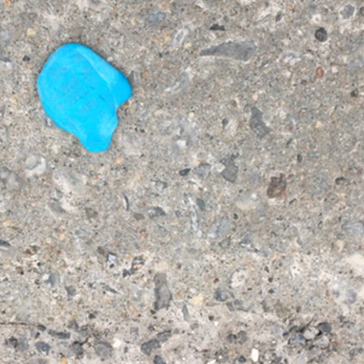 Picture of squished sticky tack on the sidewalk